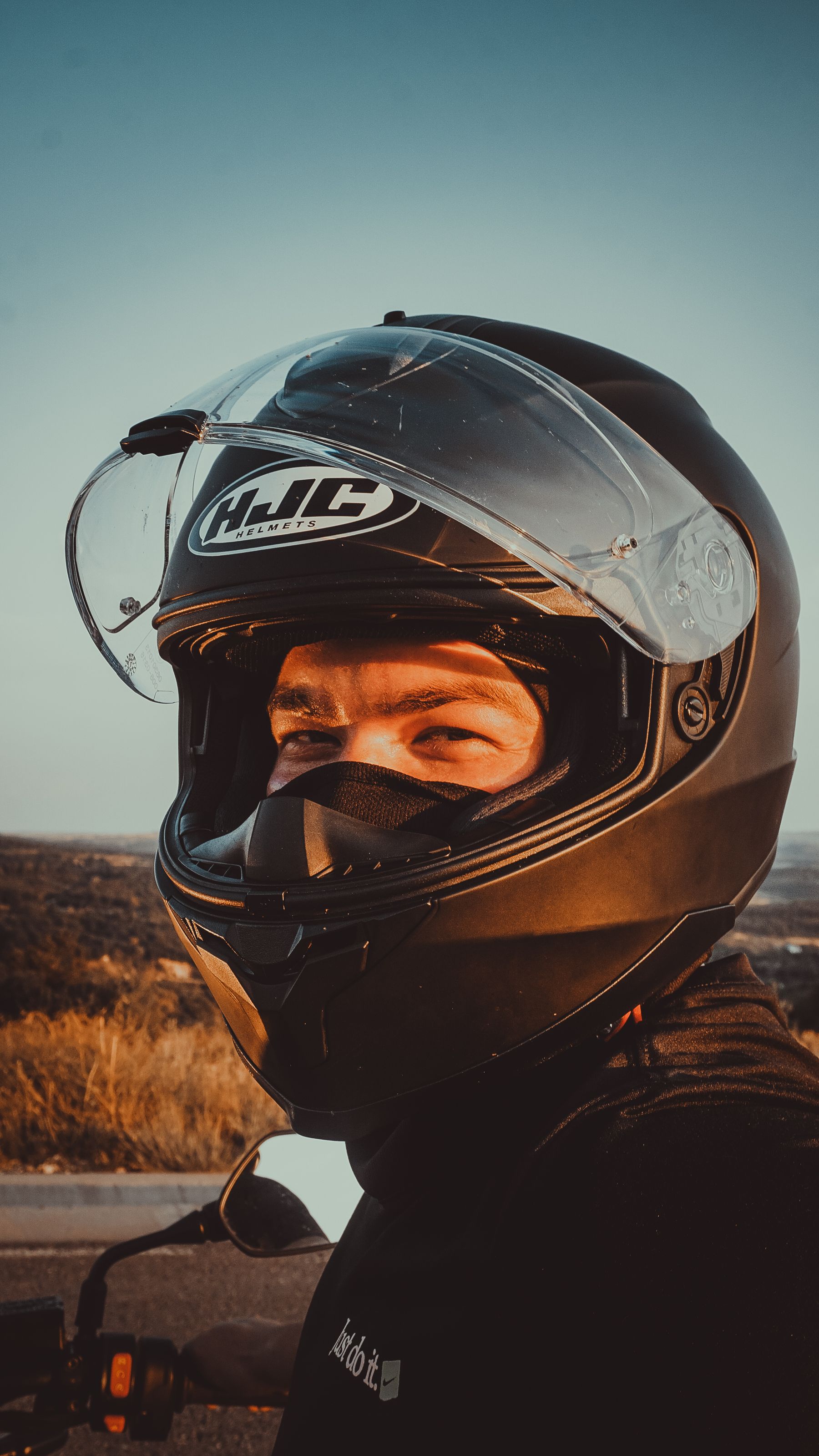 Motorcyclist silhouetted against a low sun